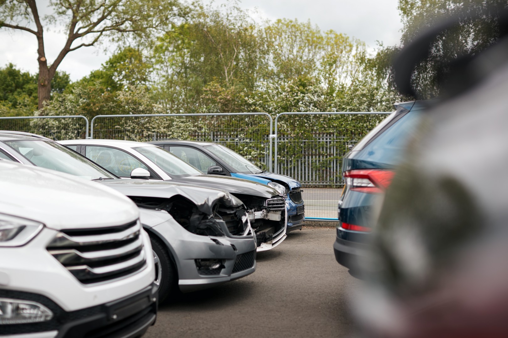 Cars Damaged In Motor Vehicle Accidents Parked In Garage Repair Shop